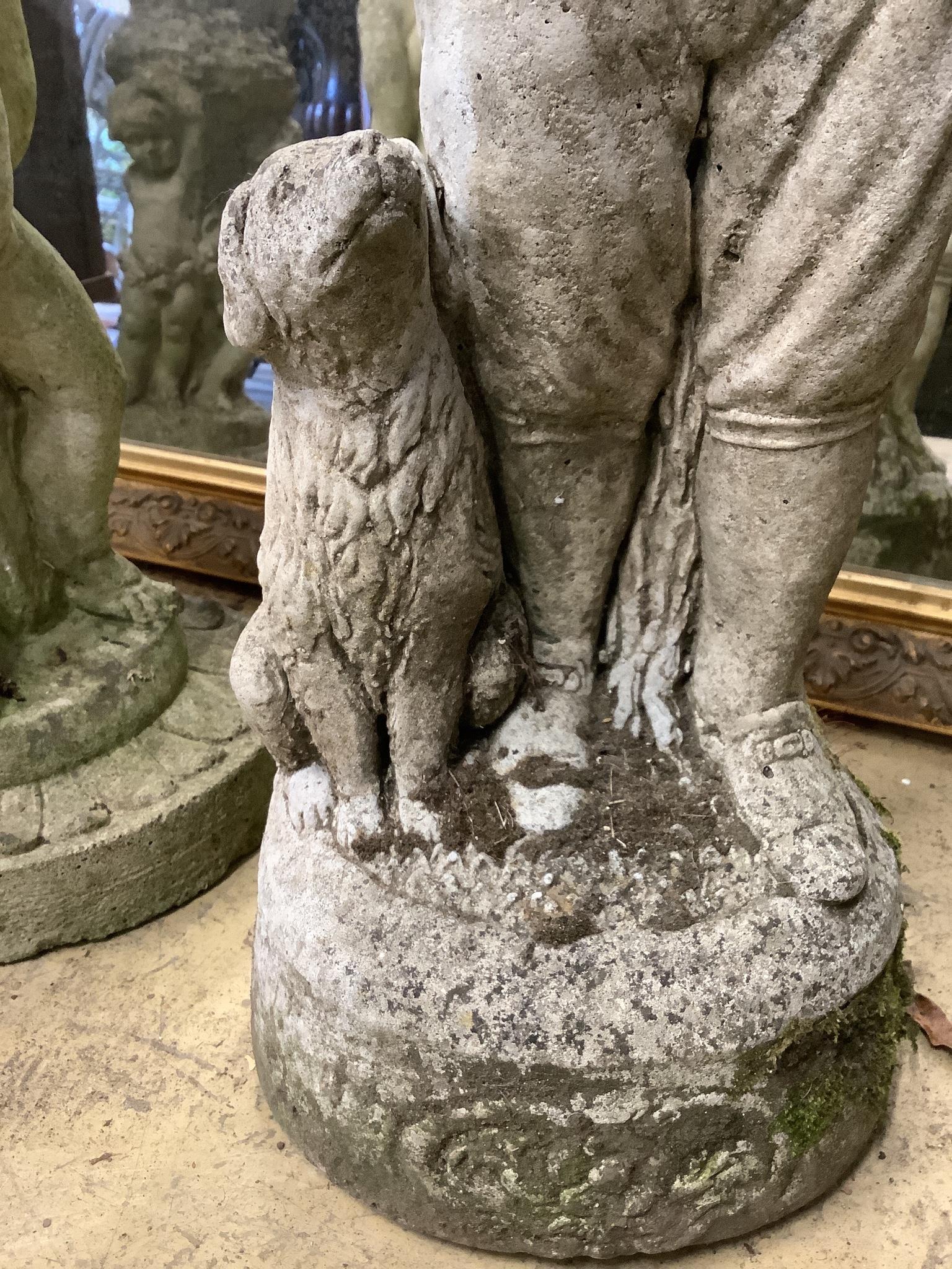 A reconstituted stone garden ornament of a boy with dog, height 69cm